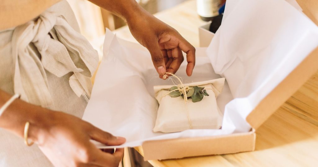 woman jewelry business owner packing order