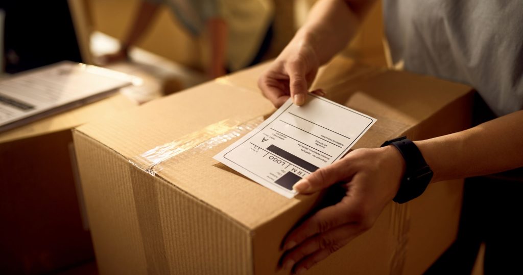 closeup attaching address label package