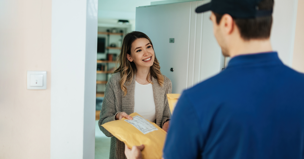 happy woman taking package from courier